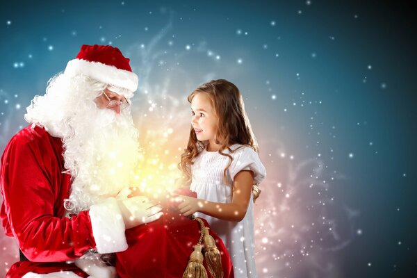 Santa Claus opens a bag of gifts to deliver one of them to a little girl