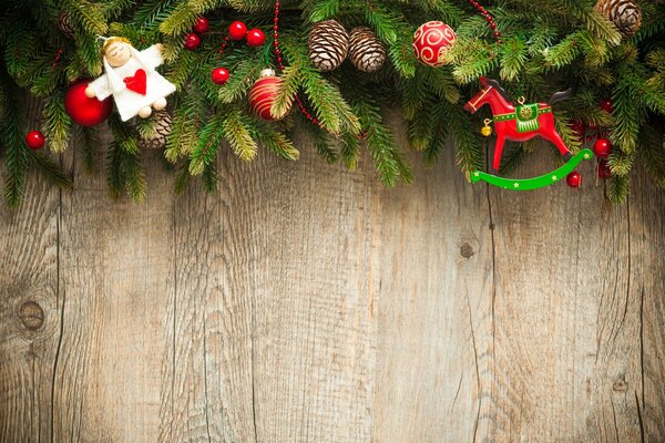 Spruce branches and cones on the background of a wooden table