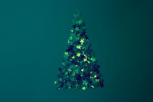 Christmas tree made of sequins on a green background