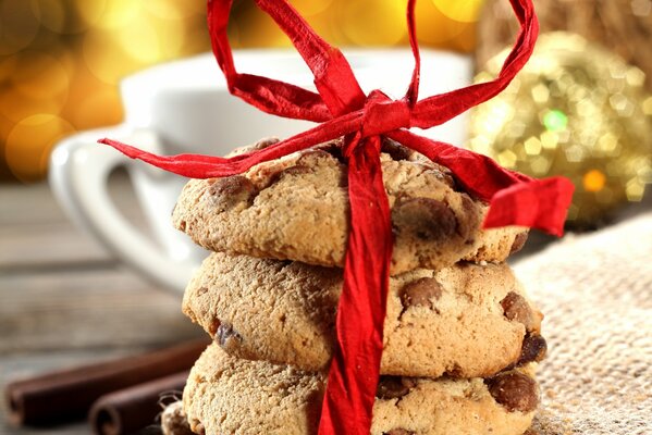 Three cookies wrapped in a red ribbon