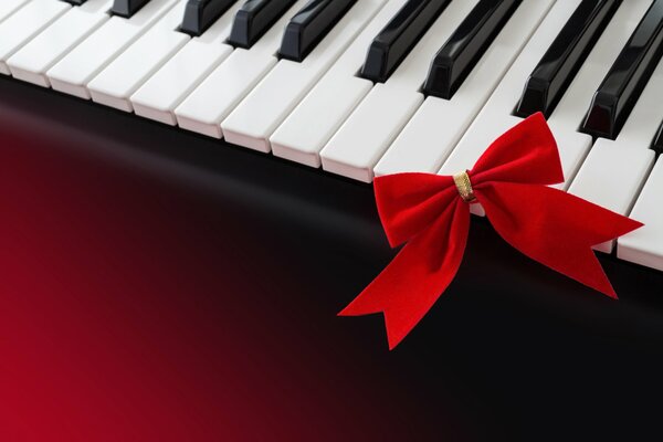 Piano with a red bow on a red background