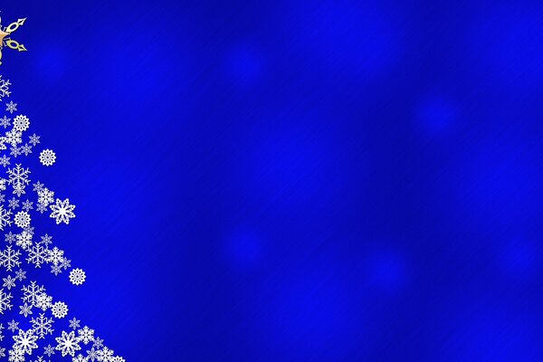 Snowy silhouette of a Christmas tree on a blue background