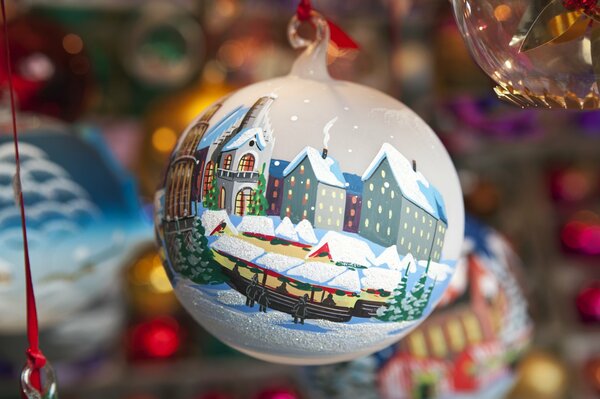 The New Year s ball is painted with huts snow houses and Christmas trees