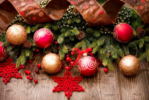 Christmas tree branches decorated with cones and golden and red toys