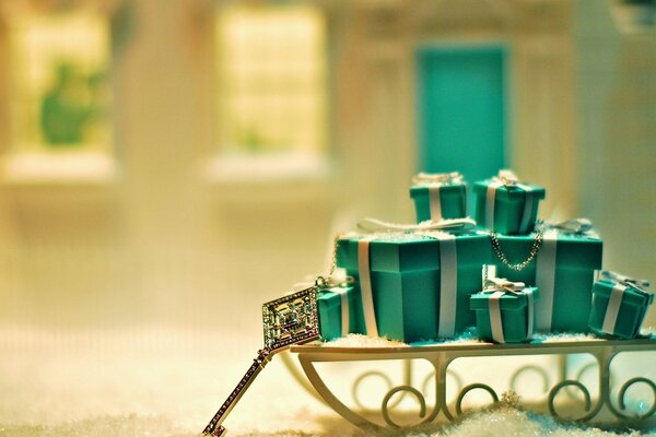 Gifts on a sleigh. A beautiful key