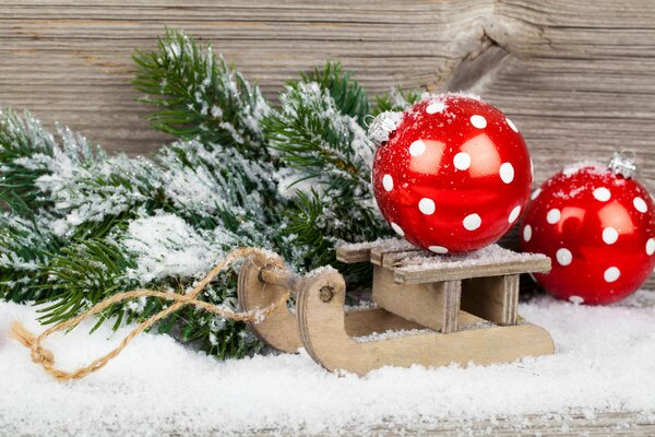 Red Christmas toys on a mini sled