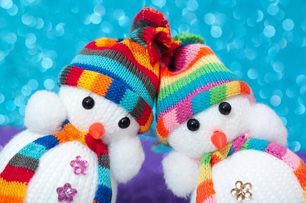 Snowmen in hats are like two twin brothers