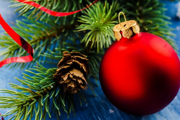 Big red ball on the background of the Christmas tree