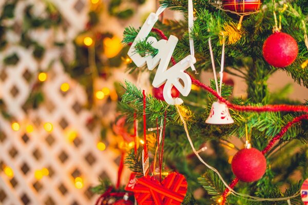 The Christmas tree is decorated with red toys beads and hearts