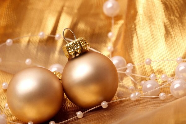 Золотые шарики и бусы для украшения елки на Новый год