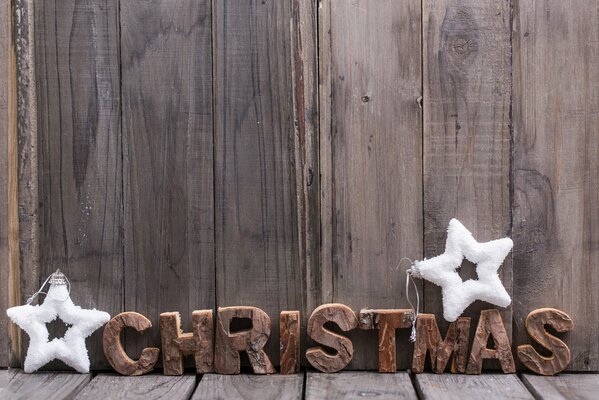 Inscription de Noël avec deux étoiles de neige blanches