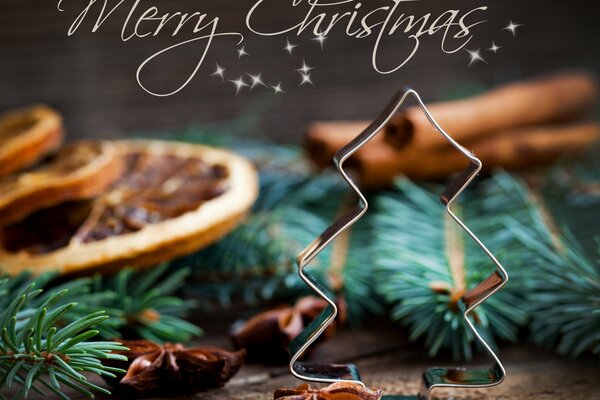 Kartka z życzeniami o tematyce Wesołych Świąt z kształtem choinki, gałązek i goździków