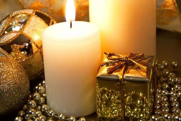 Candles and gifts on a golden background