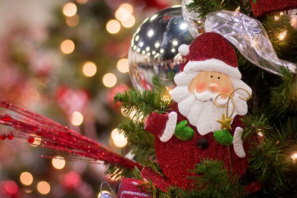 Santa Claus flaunts on the Christmas tree, toys and decorations