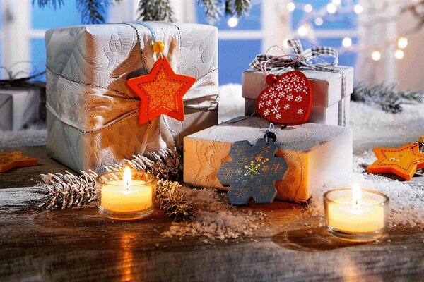 New Year s gifts on the background of burning candles