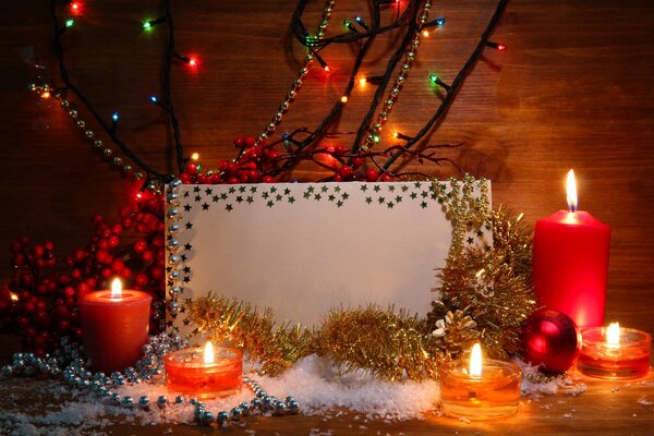 Candles, a card and tinsel in the twilight