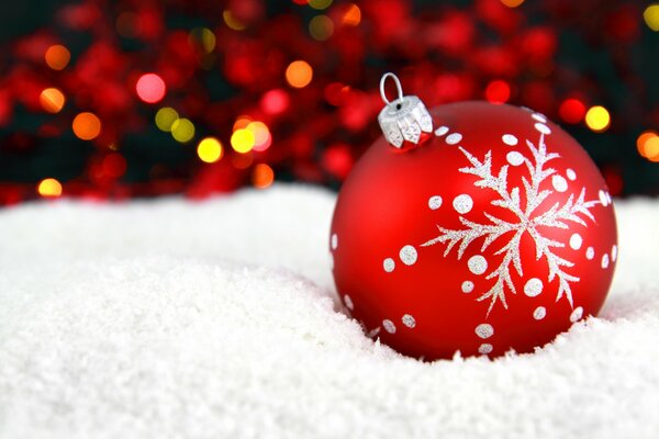 Boule de Noël rouge sur la neige