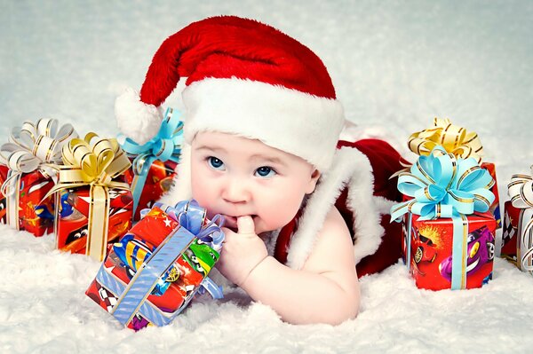 Baby im Neujahrskostüm mit Geschenken