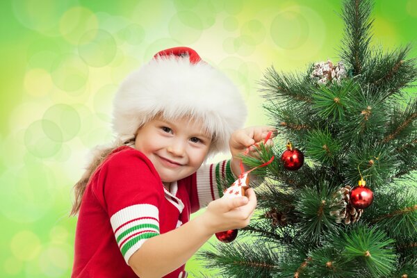 A boy stands at the Christmas tree