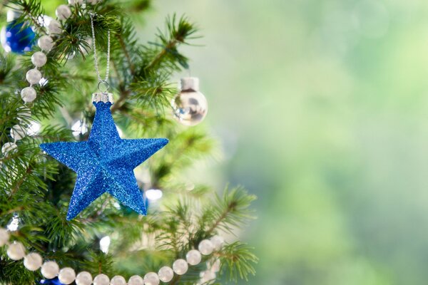 Blue Christmas tree decoration in the form of a star on the Christmas tree