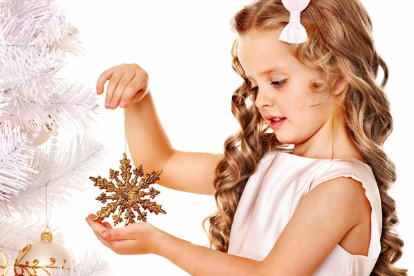 A golden snowflake in the hands of a girl