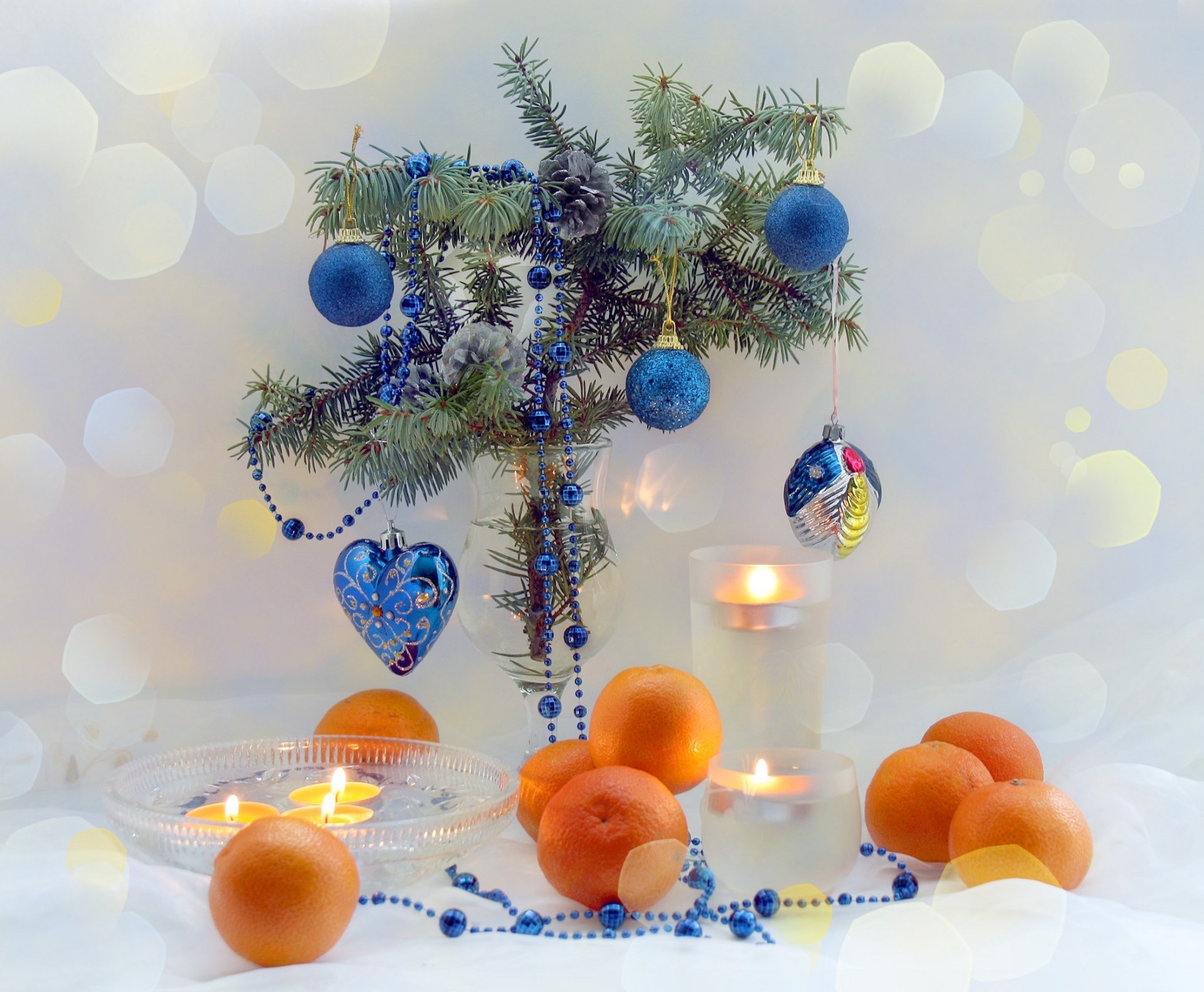 new year holiday happy new year rest fruit citrus tangerines christmas tree branches table candles blue color heart