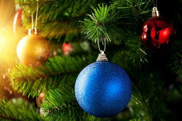 Balls on the Christmas tree in yellow, blue and red colors