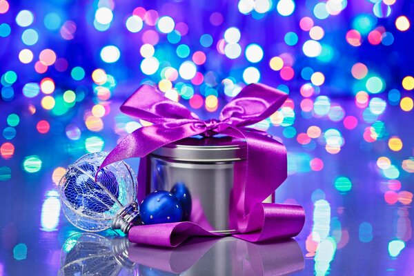 A gift with a ribbon on the background of lights