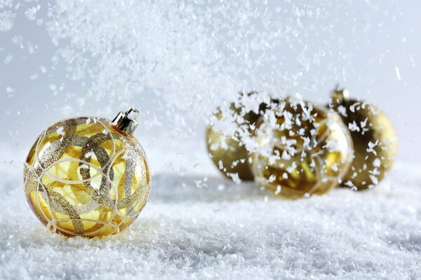 Golden Christmas balls in the snow