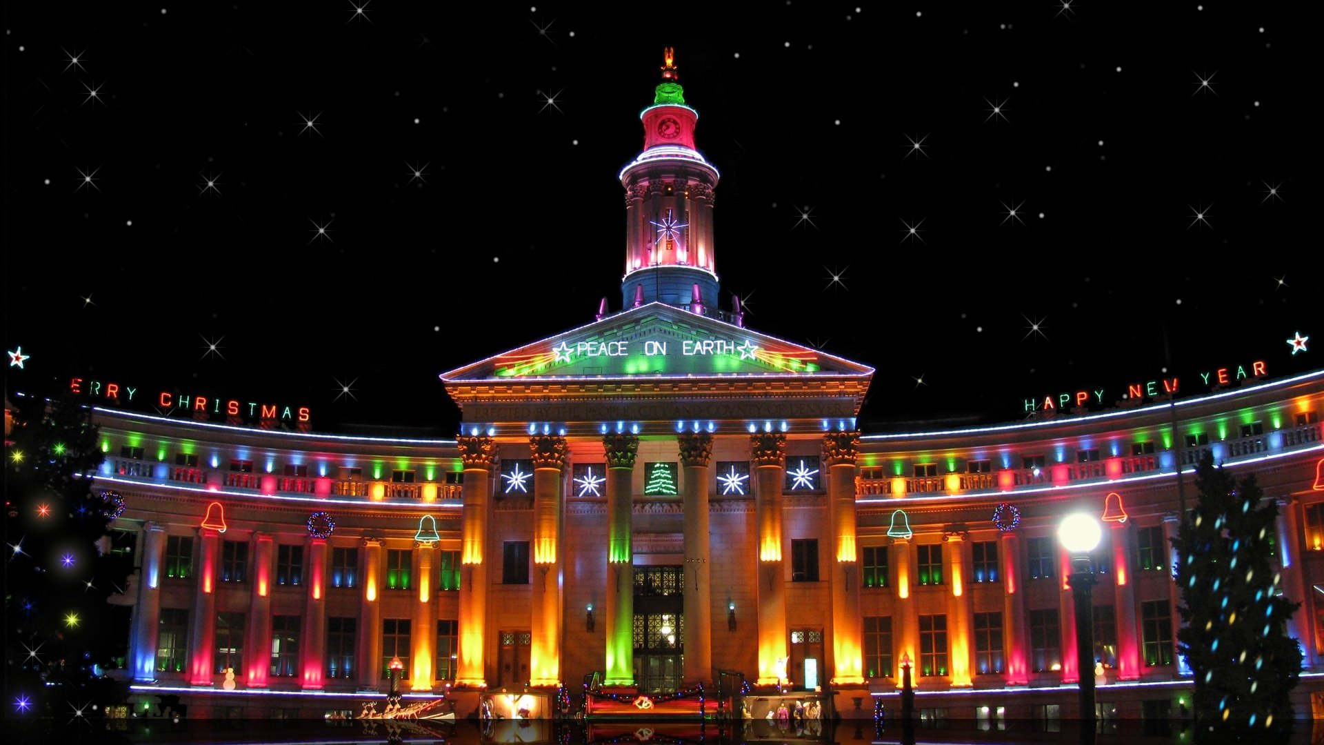 nouvel an ville bâtiment mots joyeux noël bonne année paix sur terre denver usa multicolore lumières nuit rétro-éclairage arbres de noël tour horloge