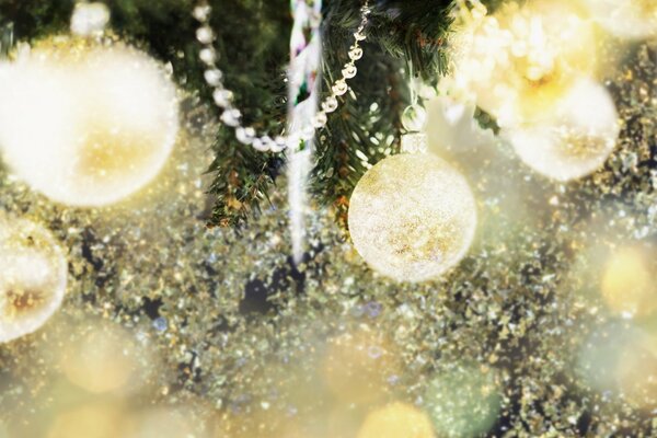 The fir tree is decorated with Christmas balls and garlands