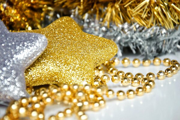 Silver-gold decorations on the Christmas tree in the form of stars