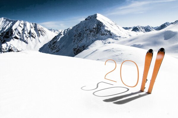 Image of the figure 2011 with the help of skis on the background of snow-capped mountains