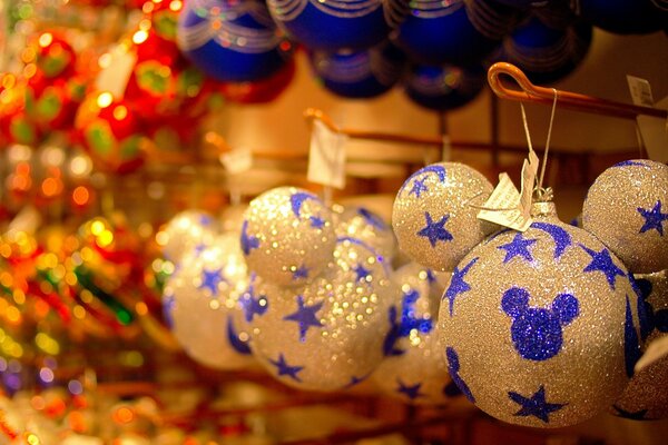 Christmas balls with blue sequins in the shape of Mickey Mouse with stars