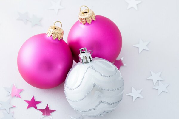 The balls are pink and white with stars on a white background