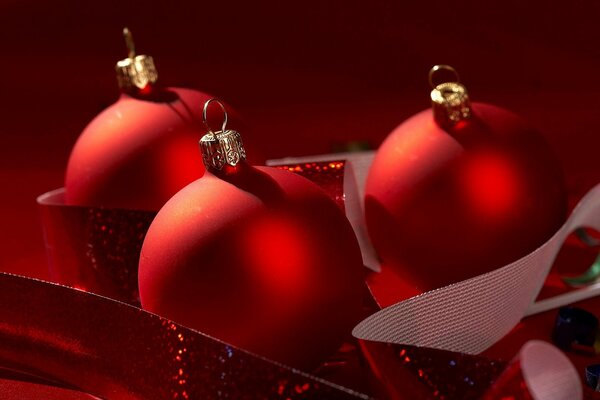 Christmas red balloons with ribbon on a red background