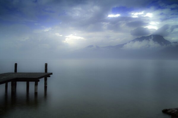 A lonely pier on a lake in the mountains