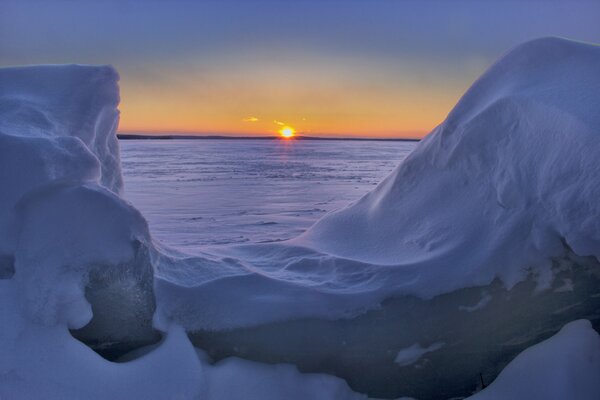 View of the frozen lake through snowdrifts