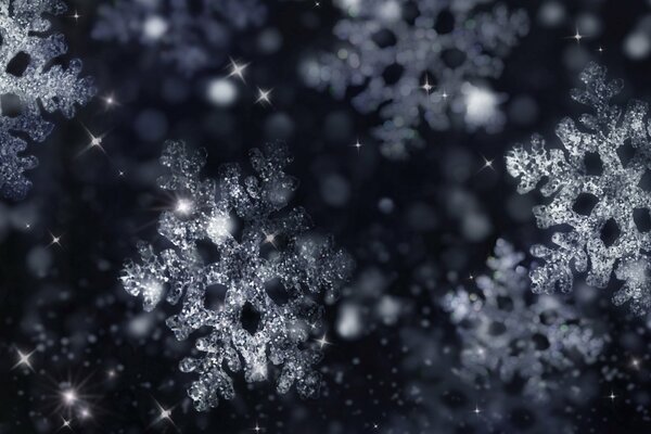 Shiny snowflakes and highlights on a black background