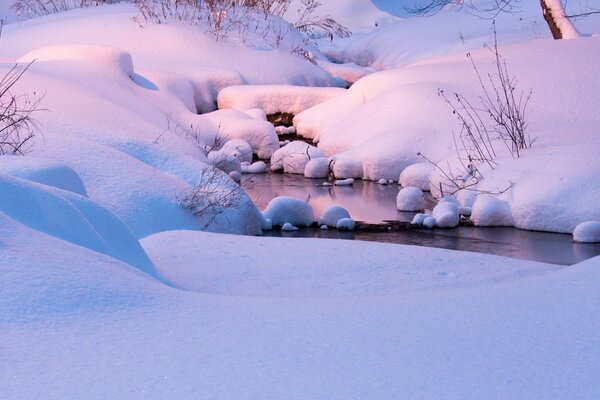 A stream in huge snowdrifts