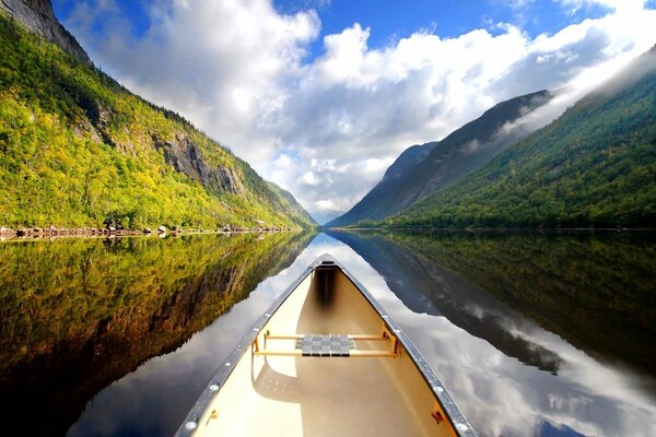 New Zealand landscape. Canoe floats on a narrow river