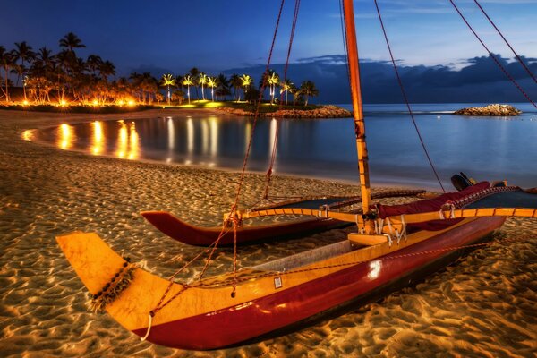 Boat on the sand in the middle of the night lights