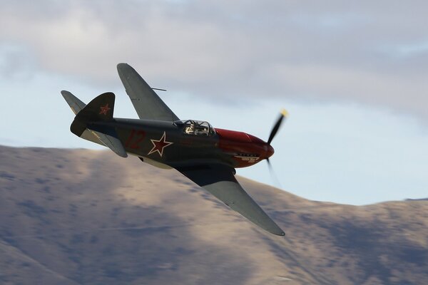 Single-engine front-line fighter Yak-3m flies in the sky