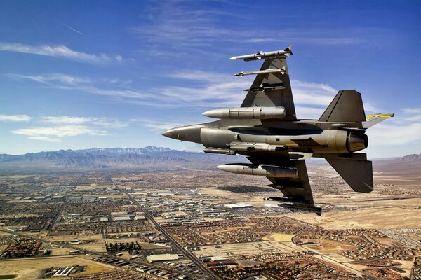 An American fighter jet flying over the city