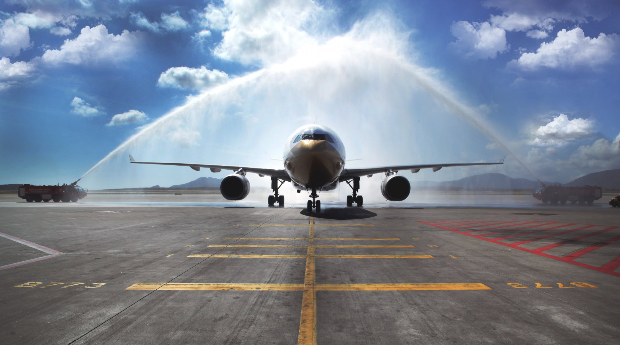 airbus a330 passenger plane airliner day sky meeting of the aircraft arch fire trucks watering