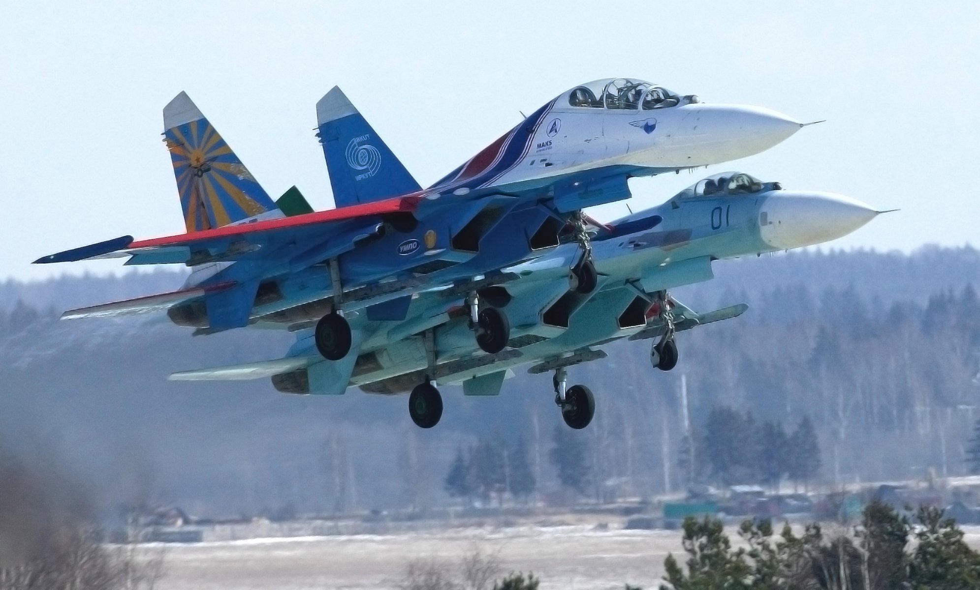 russian knights aerobatic team russia su27 two fighter multi-purpose fourth generation su-27p su-27ub day in the air top forest off aviation plane air force wings a side view