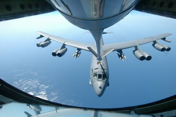 Refueling in the sky over the ocean of a B 52 strategic bomber