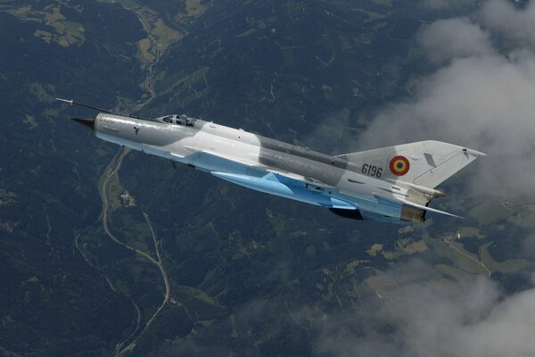 A beautiful view of the flight in the clouds of the Mig-21 fighter