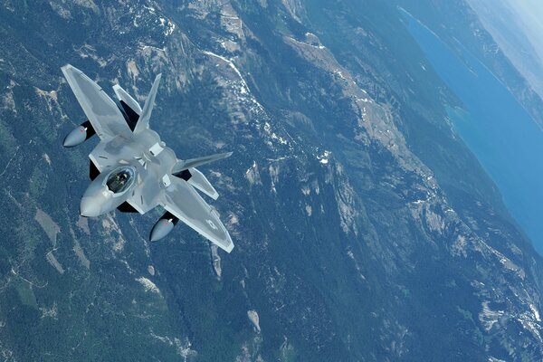 US Air Force F22 Raptor fighter in the sky over the coast