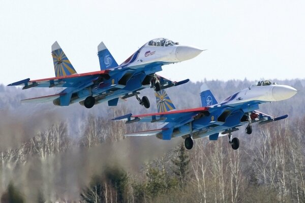 Russian knights on the su 27 fly over the ground
